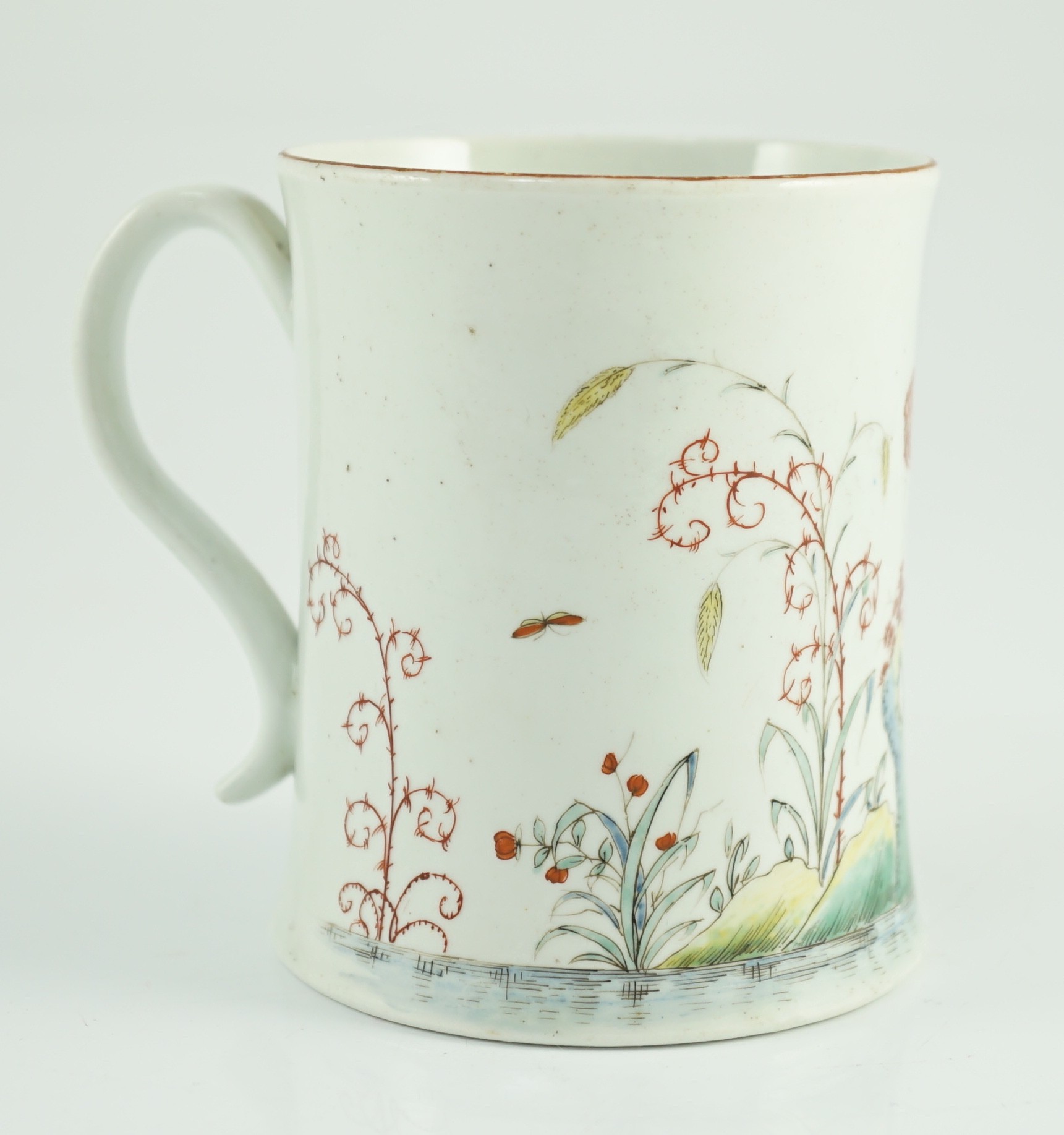 A rare Worcester polychrome 'flower and rockwork' small mug, c.1753-54, 9cm high